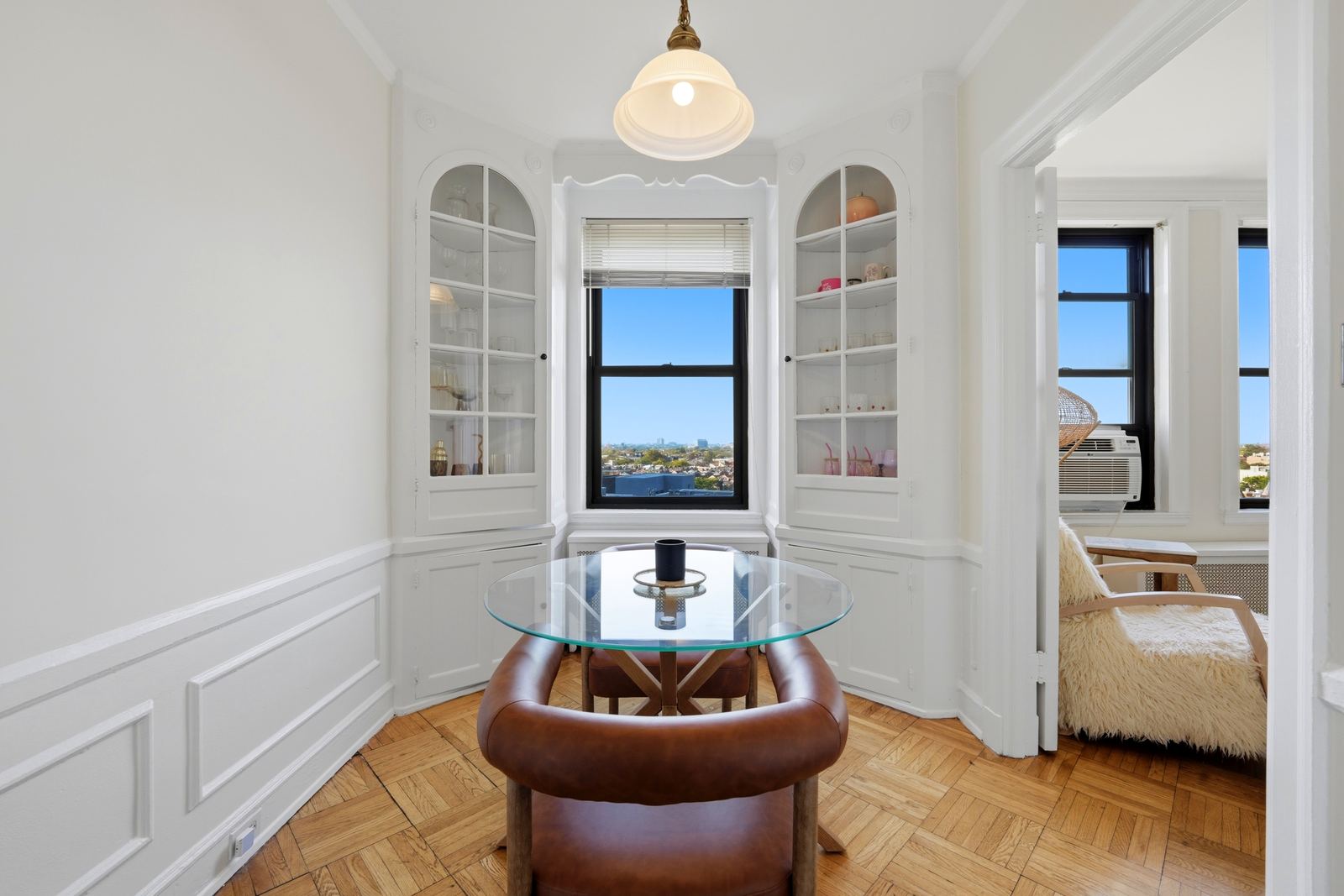 A dining nook with arched corner cabinets in a Lincoln Park condo, photographed for Hannah Roche